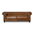 Brown leather sofa with tufted backrest on a white background