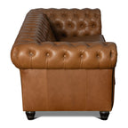 Brown leather sofa with tufted backrest on a white background